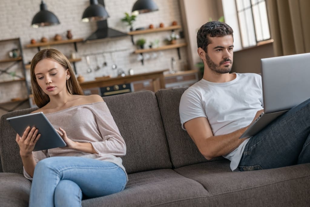 Couple Busy On Laptop